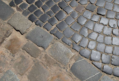 Cobblestone street and pavement texture. Diagonal separation. Abstract background of old cobblestone.の写真素材