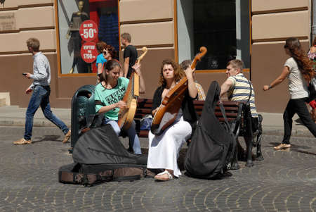 Lvov, Ukraine - July 22, 2016: Street musicians on Market Square, one of the most famous and busiest shopping square in Ukraine. Girls playing on bandura. Bandura - ukrainian folk stringed musical instrument.のeditorial素材