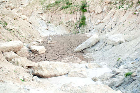 The cracks on the parched earth at a forsaken quarryの写真素材