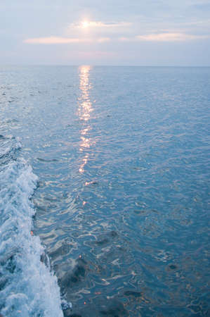 The track on the sea surface from the rising sun, backgroundの写真素材