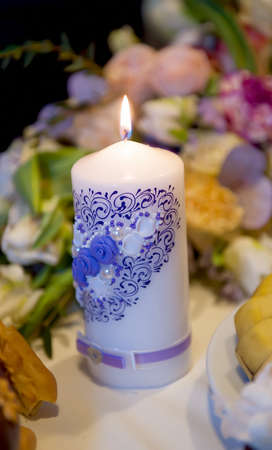 Burning candles on a wedding table of newlywedsの写真素材