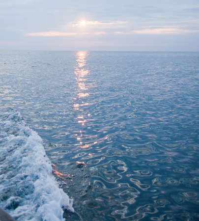 The track on the sea surface from the rising sun, backgroundの写真素材