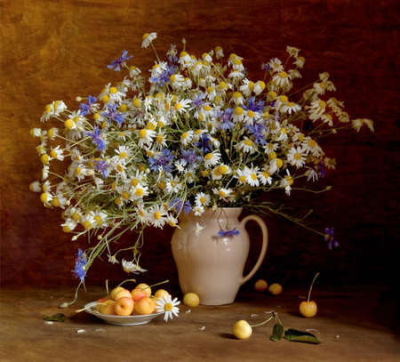 Still life with wildflowers and sweet cherry, looking like a paintingの写真素材