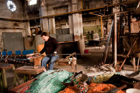Murano island, Venice, Italy - October 29 2012: Glassblowing artisan at work in a crystal glass workshop in Murano island Venice Italy. Murano glassmakers use the same tools as their ancestors have thousands of years agoのeditorial素材