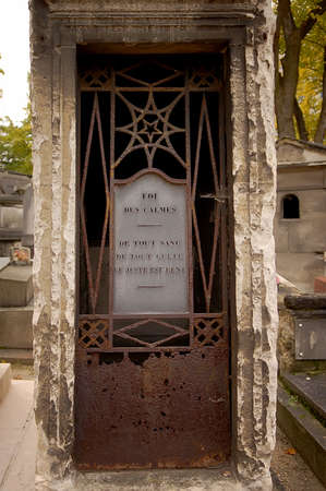 Old ornate iron door. Entrance to an old tomb, crypt at a cemetery.のeditorial素材
