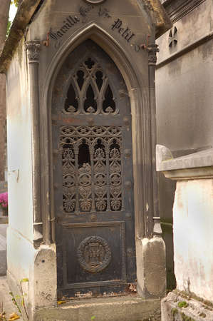 Old ornate iron door. Entrance to an old tomb, crypt at a cemetery.の写真素材