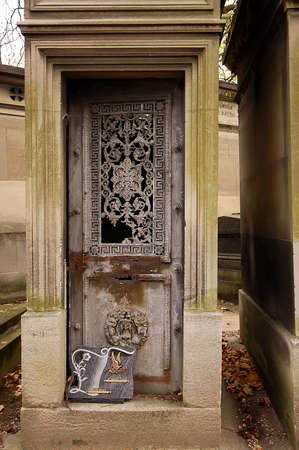 Old ornate iron door. Entrance to an old tomb, crypt at a cemetery.の写真素材