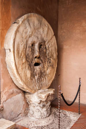 The Mouth of Truth (La Bocca della Verita) carved from Pavonazzo marble, in the portico of the church of Santa Maria in Cosmedin in Rome, Italyのeditorial素材