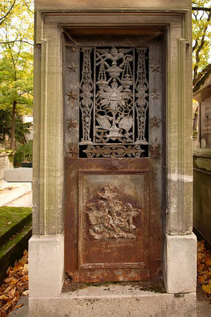Old ornate iron door. Entrance to an old tomb, crypt at a cemetery.の写真素材