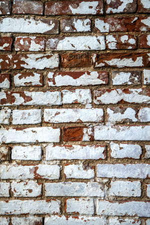 Old vintage brick wall with sprinkled white plaster texture backgroundの写真素材