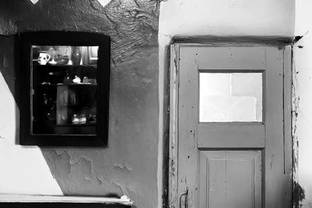 Entrance of old country house, featuring a mirror with a reflected cupboardの写真素材