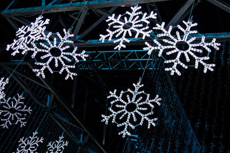 Closeup of silver glitter snowflakes decorated on artificial Christmas tree at outdoor