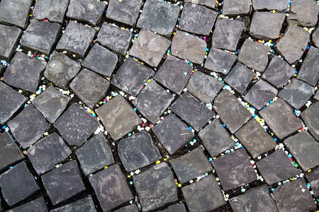 Texture of stone pavement tiles cobblestones with colorful confettiの写真素材