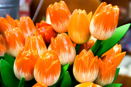 Orange plastic decorative artificial tulips, close-up, backgroundの写真素材