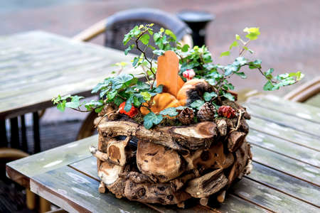 Decorative pot on the wooden table of a street cafe. Selective focusの写真素材