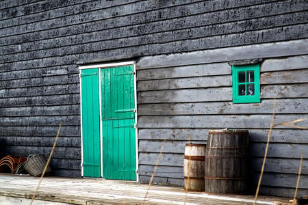 Old wooden barrel on the background of a wooden barn. Selective focusの写真素材