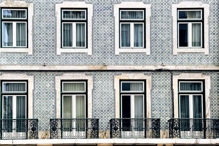 Lisbon windows with typical portuguese tiles on the wallの写真素材