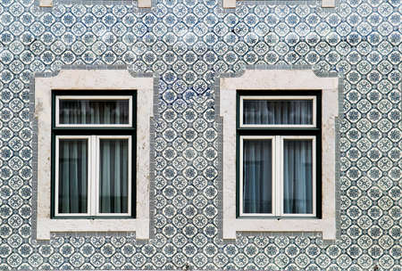 Lisbon windows with typical portuguese tiles on the wallの写真素材
