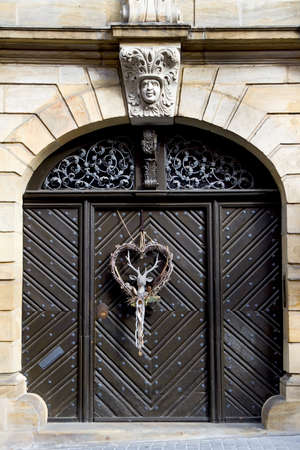 Decorative christmas season wreath with a deer on a wooden doorの写真素材