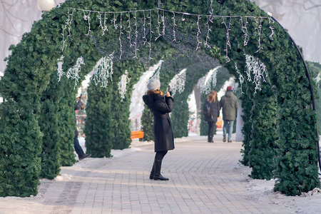 Kyiv, Ukraine - January 17, 2017: People and tourists walk in the Mariinsky Park decorated to Christmas winter holidays. It is one of the most visited amusement parks in Kyiv. Selective Focus.のeditorial素材