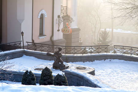 Early morning in the quiet town, at the background statue of Ukrainian faitytale character Kotygoroshko beating up the Dragon. Selective focus.の写真素材