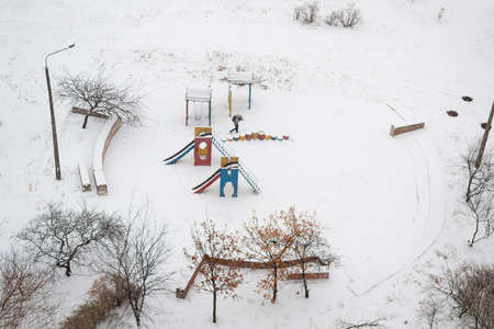Children's playground covered with snow in winter. Selective focusの写真素材