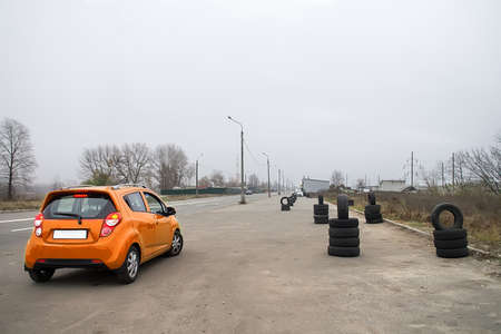 Modern car and safety tires in driving school outdoorsの写真素材
