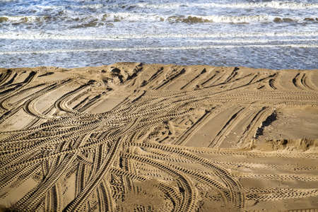 Tire tracks on the sand of the beach. Selective focusの写真素材