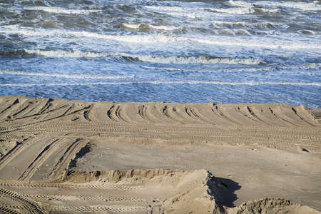 Tire tracks on the sand of the beach. Selective focusの写真素材