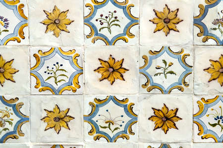 Detail of the traditional tiles from facade of old house. Decorative tiles. Floral ornament. Selective focusの写真素材