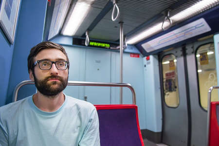 Young pretty hipster guy traveler in subway. Selective focusの写真素材