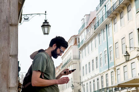 Young man on the street. Architecture background. Selective focusの写真素材