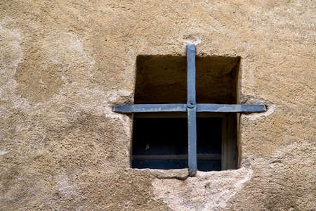 Lonely window on rough textured wall. Selective focusの写真素材
