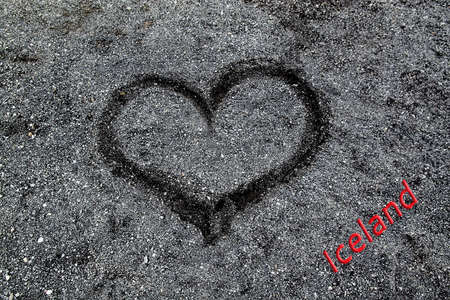 Drawing of a heart on the sand on a black beach in Icelandの写真素材