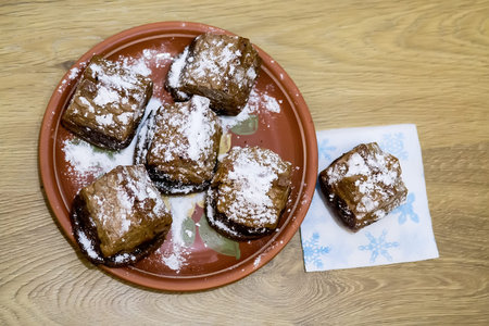 Traditional Christmas cake with nuts on wooden background. Selective focus