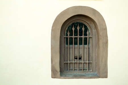 Window on the stone wall , closed by a metal grillの写真素材