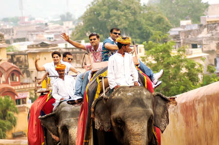 Jaipur, India - July 29, 2011: Unidentified tourists ride an elephant. Elephant rides are popular tourist attraction in Amber Fort.のeditorial素材