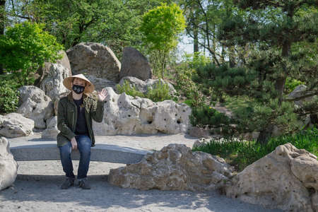 Teenager in traditional Japanese garden in Kyoto Park. Kyiv(Kiev). Ukraine. Selective focusの写真素材