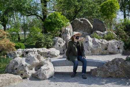 Teenager in traditional Japanese garden in Kyoto Park. Kyiv(Kiev). Ukraine. Selective focusの写真素材