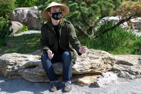 Teenager in traditional Japanese garden in Kyoto Park. Kyiv(Kiev). Ukraine. Selective focusの写真素材