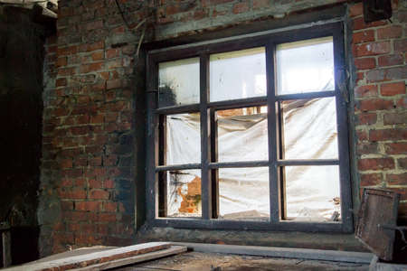 Industrial brick building with broken window. Selective focusの写真素材