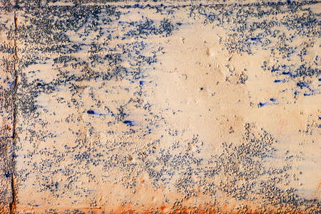 Old rusty peeling paint on an iron wallの写真素材