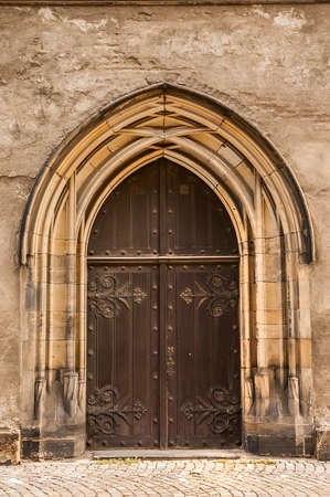 Old church textured door with stone arch facadeの写真素材