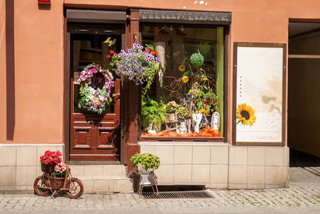 Torun, Poland - July 18, 2014: Vintage flower shop facade with colorful flower and plant potsのeditorial素材