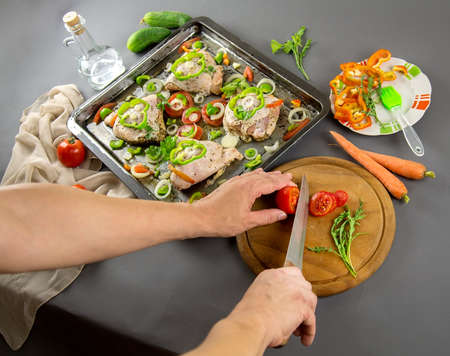 Raw chicken with ingredients for cooking on a gray background. Selective focusの写真素材