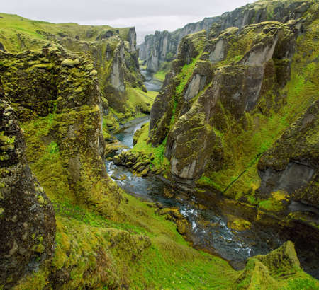 Canyon leading to the Icelandic waterfalls. Canyon with river and high cliffsの写真素材