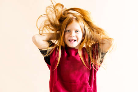The boys beautiful red hair is fluttering. Child laughs and has fun.The concept of spending time with childrenの写真素材