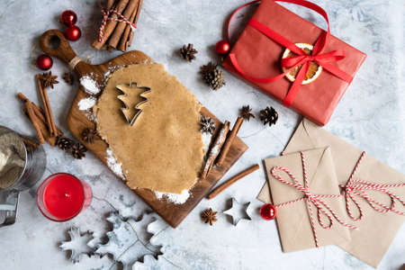 Traditional Christmas homemade gingerbread cookies, cinnamon and New Years letters and gift boxes. Flat lay with copy space.の写真素材