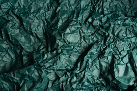 Crumpled old recycled blank empty green paper background. Eco-friendly design, eco-friendly concept for your banner on the topic of economical consumption.の写真素材