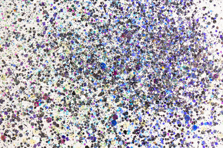 Flying luminous holographic sequins on a light pastel background. The concept of a holiday, a...